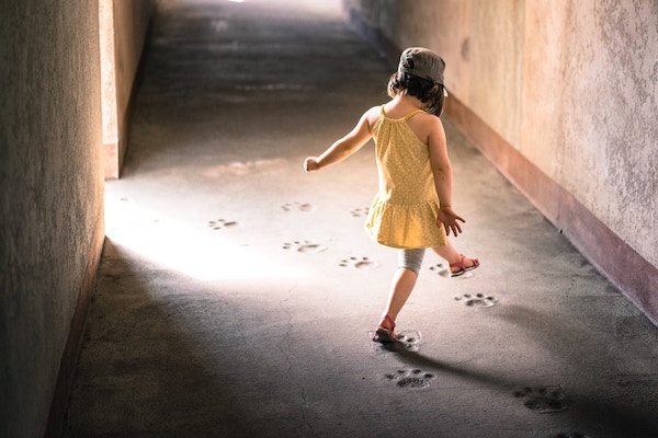 girl walking on paw prints